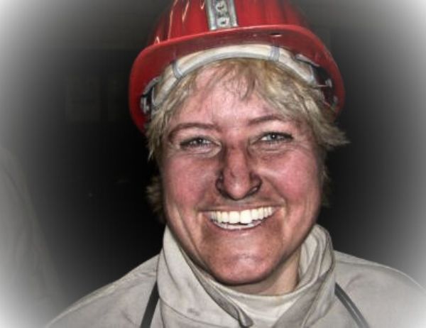 Birgit Gosejacob in miner's gear and covered in coal dust afer exploring an operative coal mine