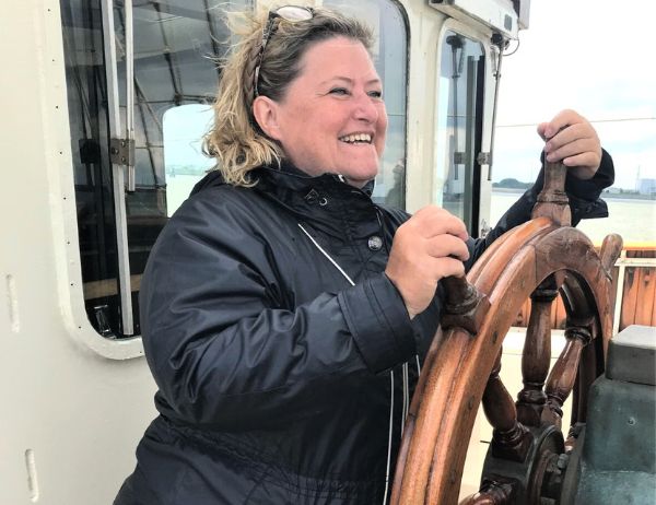 Birgit Gosejacob at the wheel of a tall ship